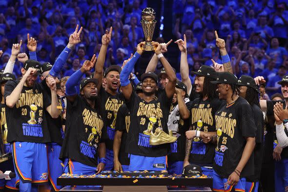 OKLAHOMA CITY, OK - JUNE 22:  Shai Gilgeous-Alexander #2 of the Oklahoma City Thunder lifts the the Larry O‘Brien Championship T